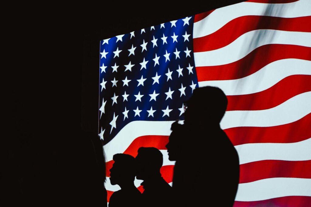 Silhouettes against the American flag representing the transatlantic partnership and US-Europe relations