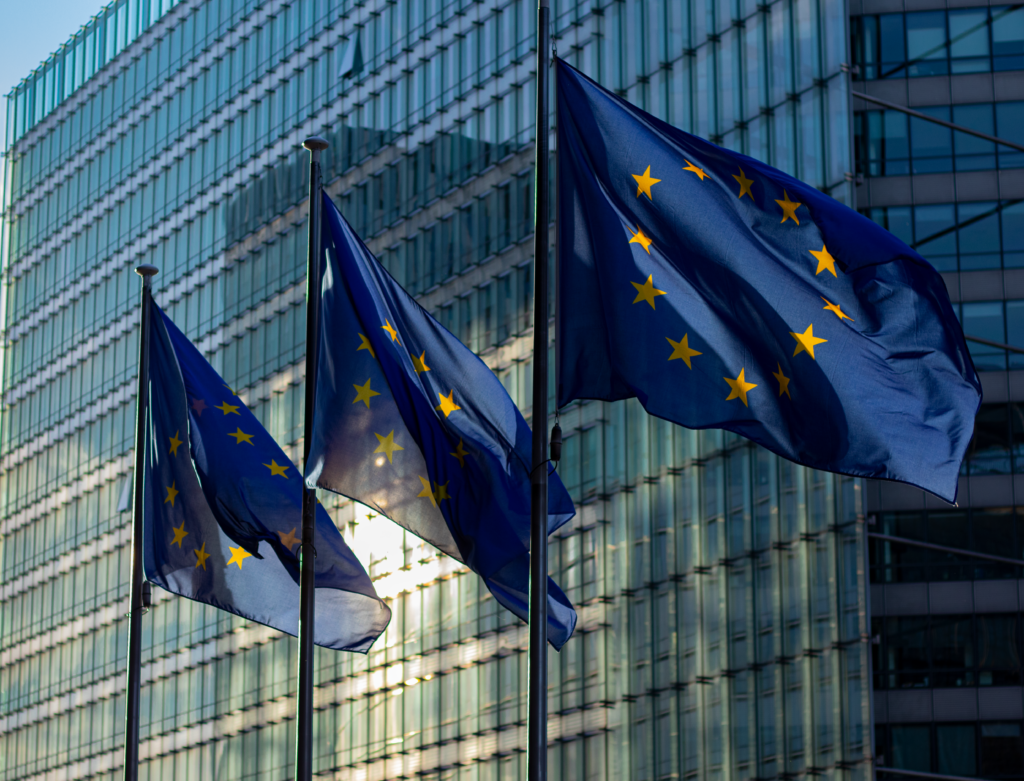 European Union flags waving in front of the European Commission building in Brussels