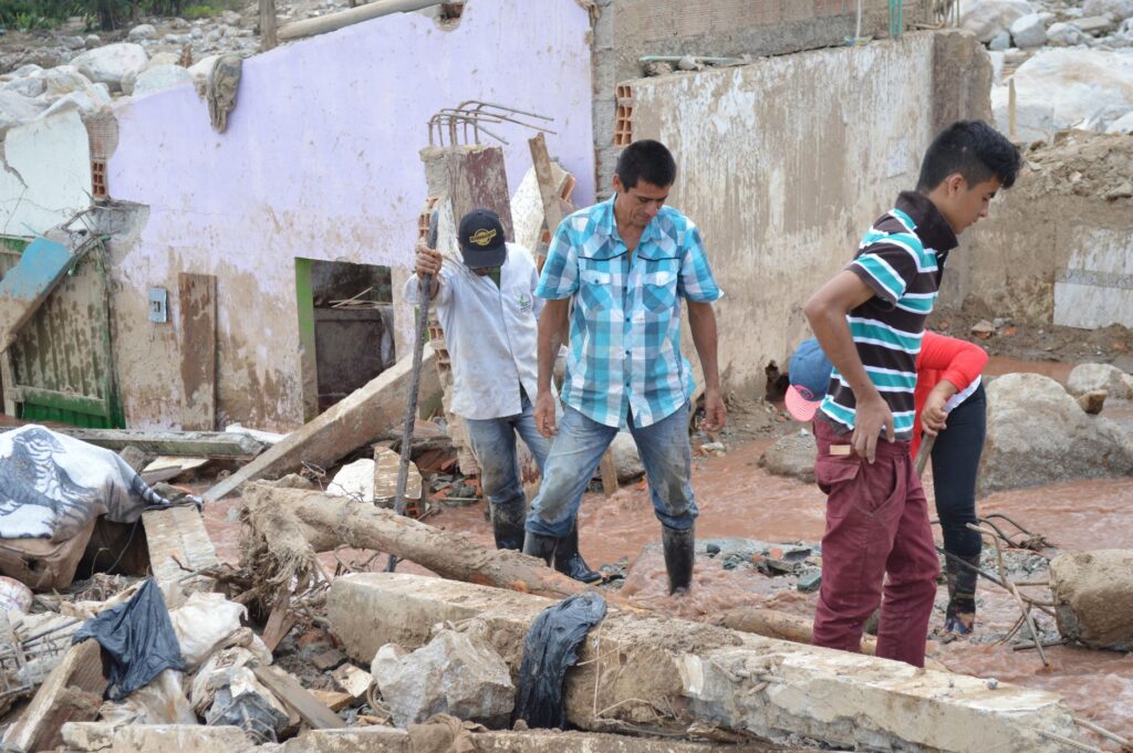 Survivors navigate debris after a natural disaster