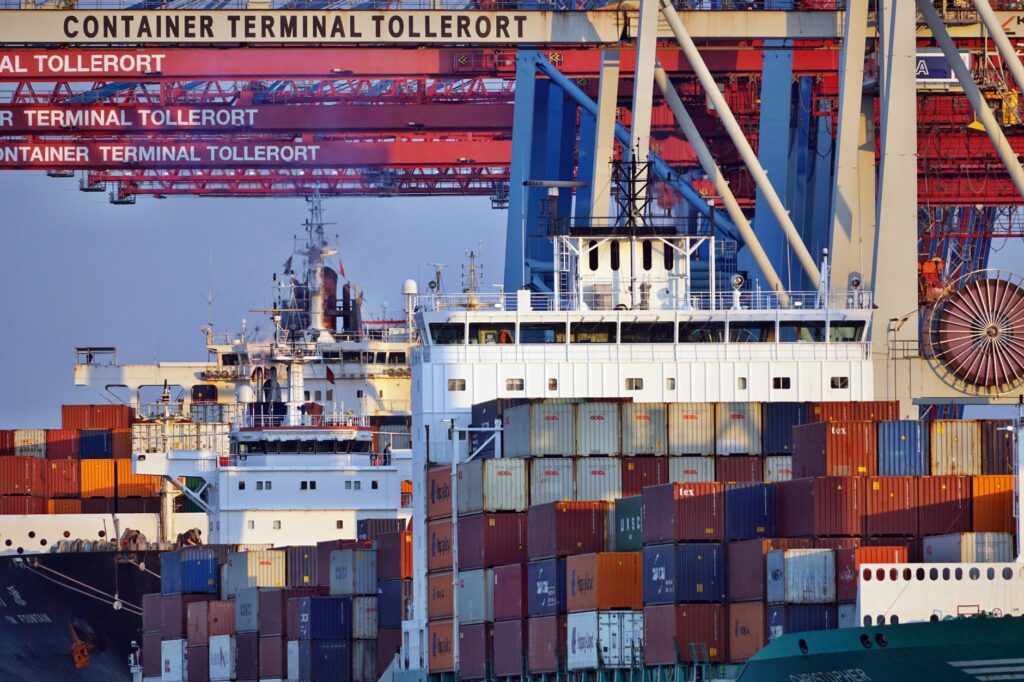 Container ships docked at a terminal in Hamburg at sunset