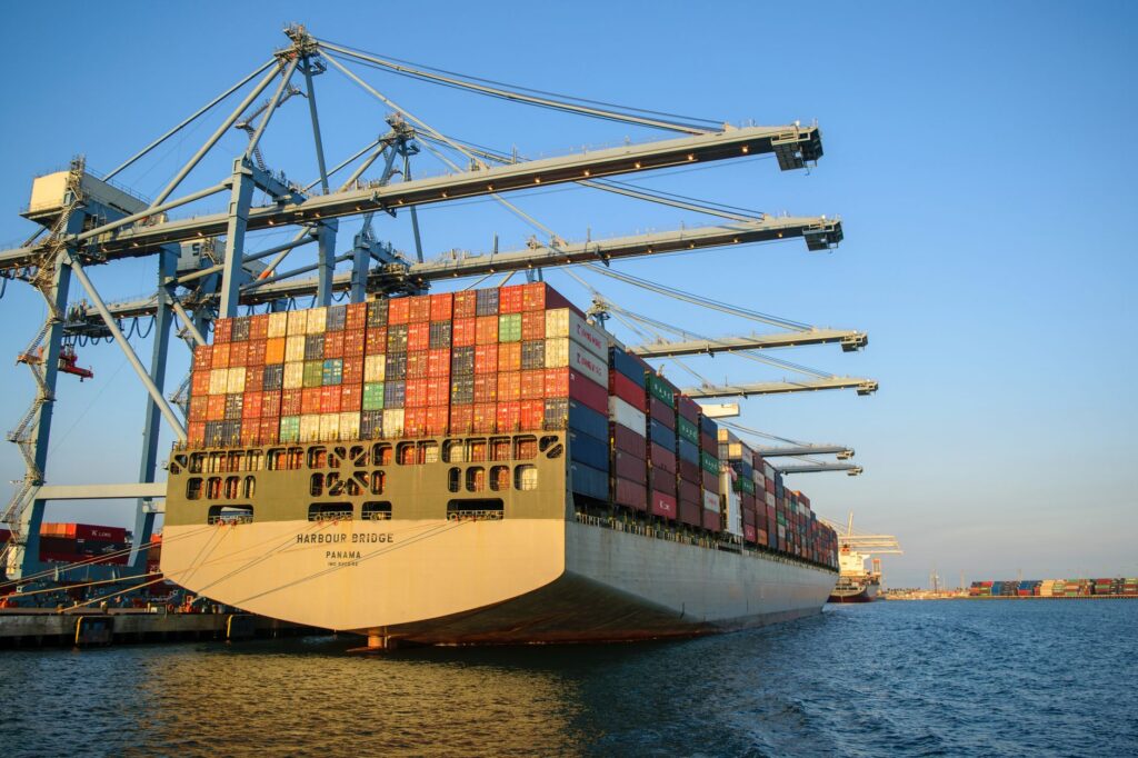 Container ship loading at a port terminal under gantry cranes