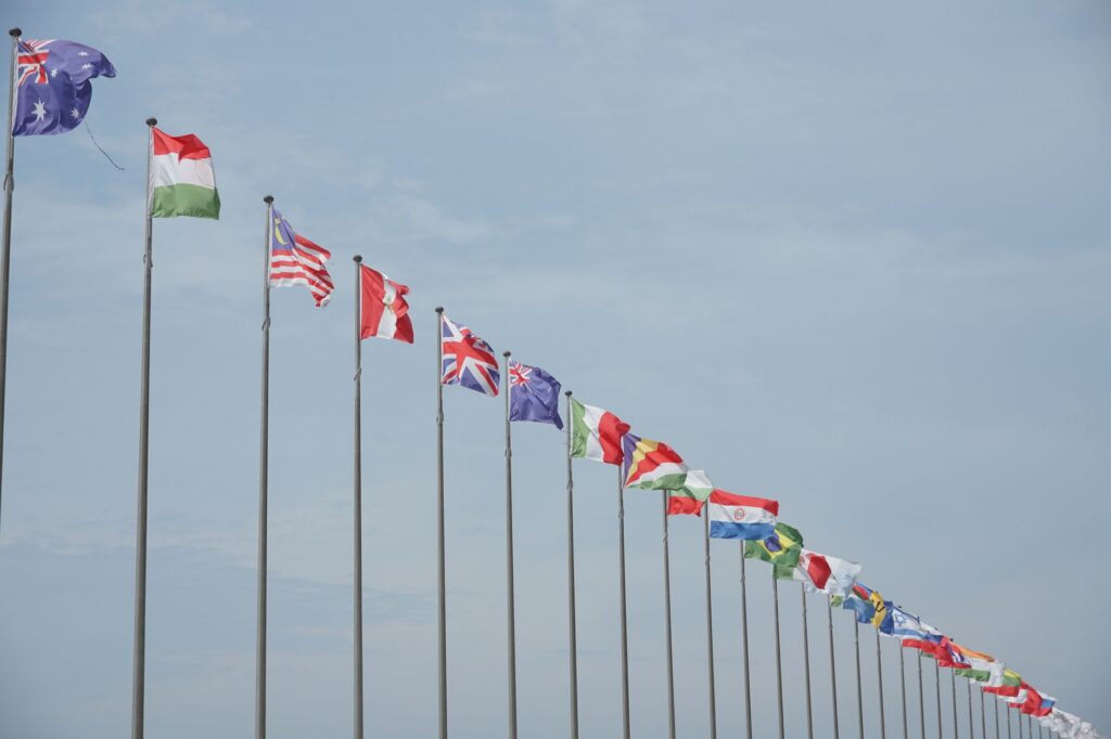 A row of international flags on flagpoles symbolizing global unity and diplomacy