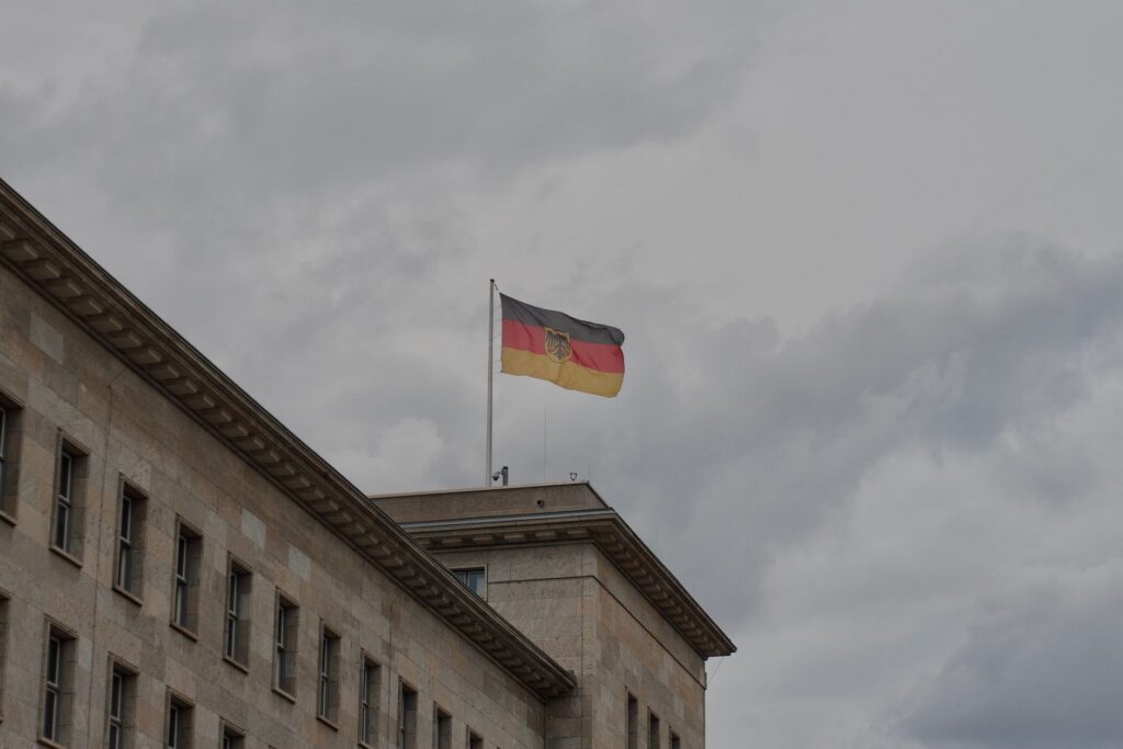 German flag waving atop a historic government building in Berlin