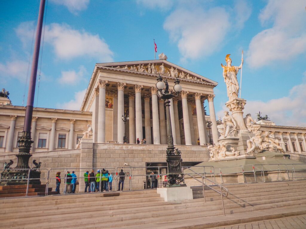 Exterior view of the Vienna Parliament Building with the Athena Fountain