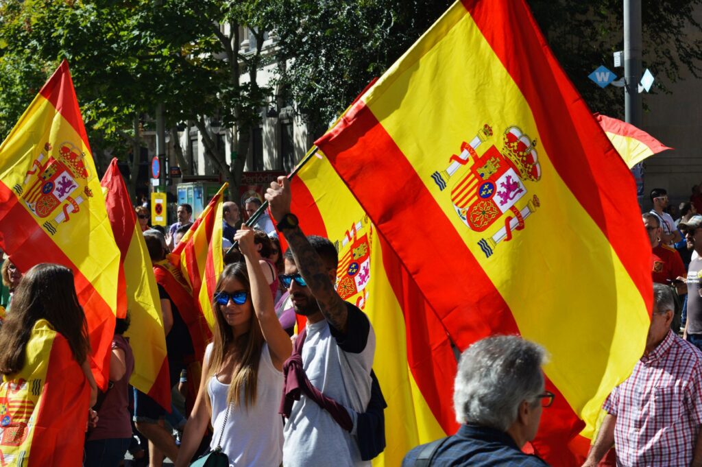 Crowd carrying Spanish flags at a street rally