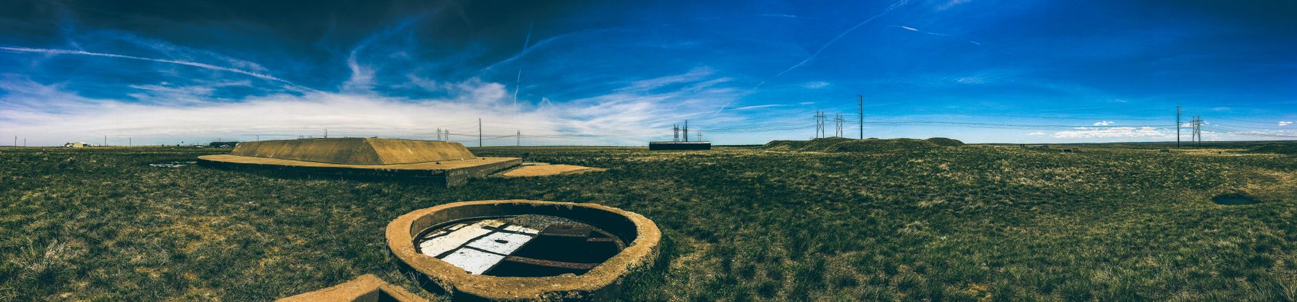 Abandoned missile silo under a clear blue sky