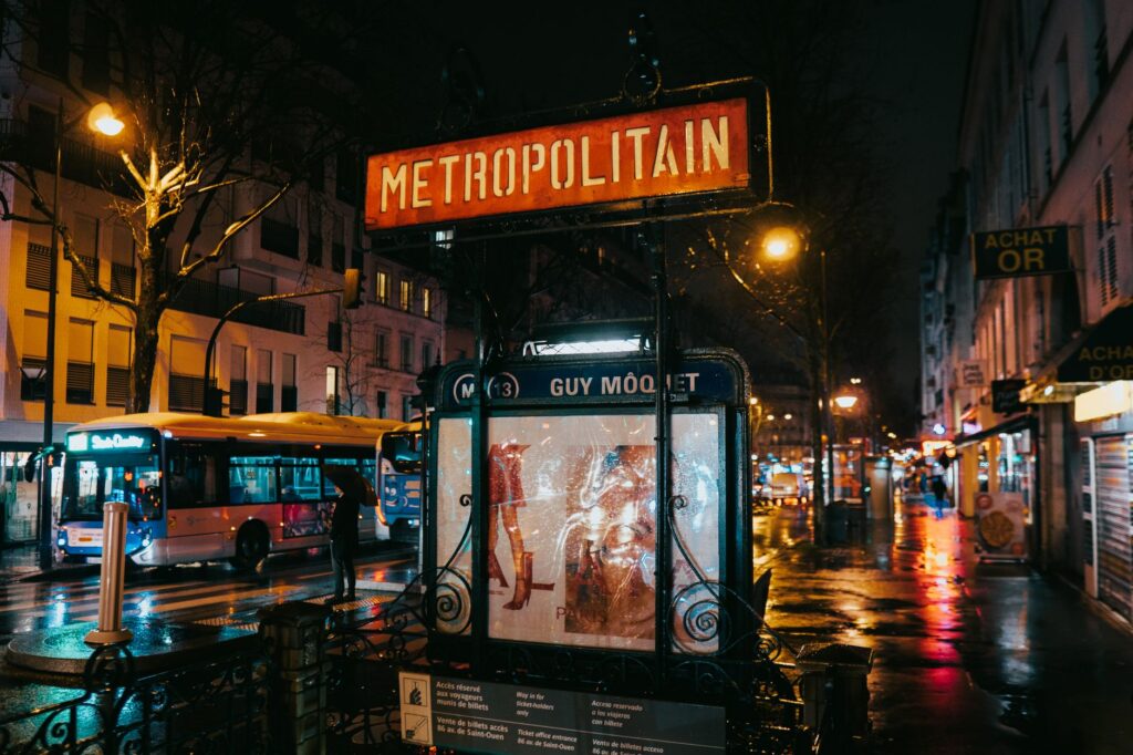A wet Paris street at night reflecting city lights
