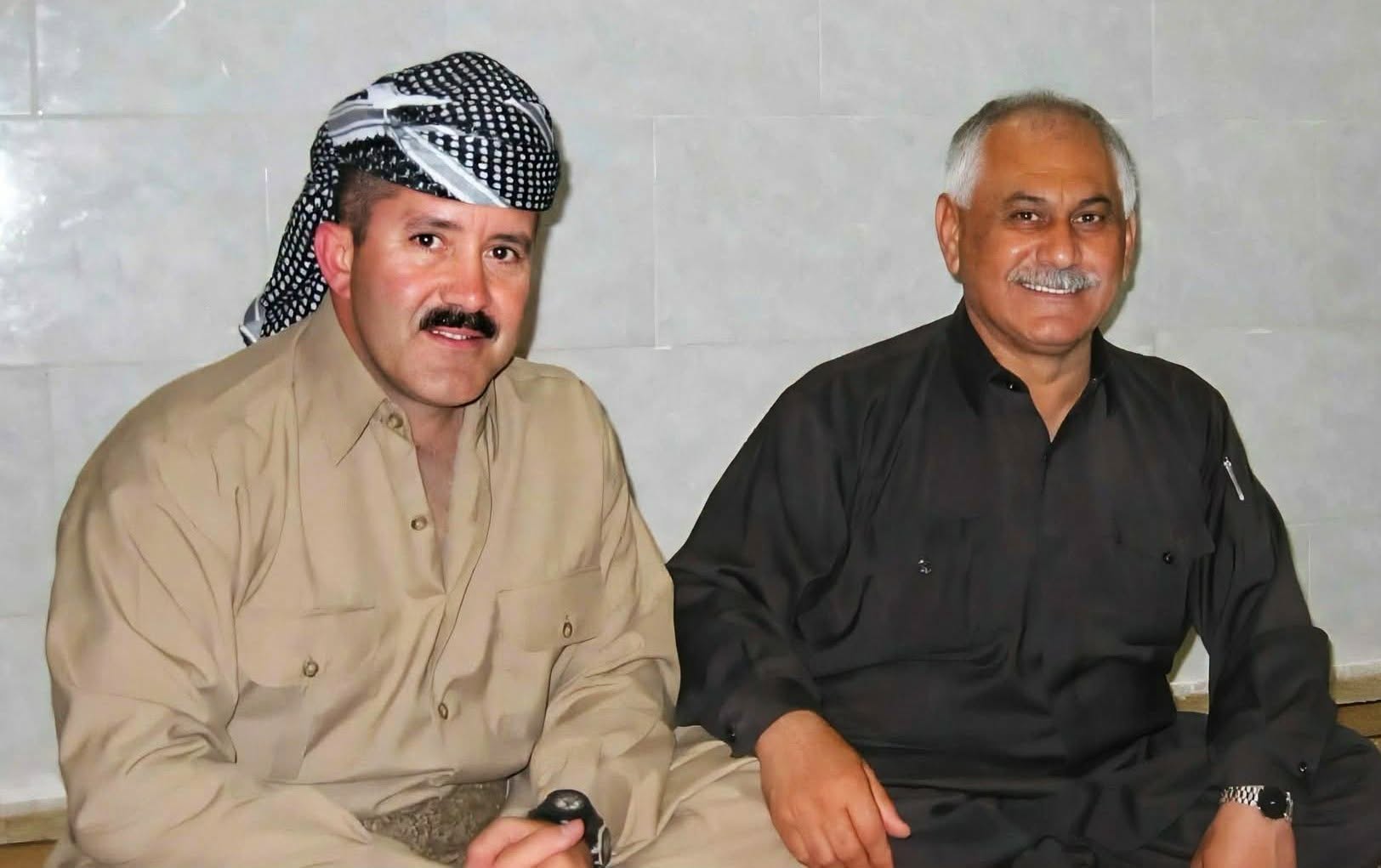 Two men in traditional Kurdish clothing seated side by side, from Ernie Audino's post