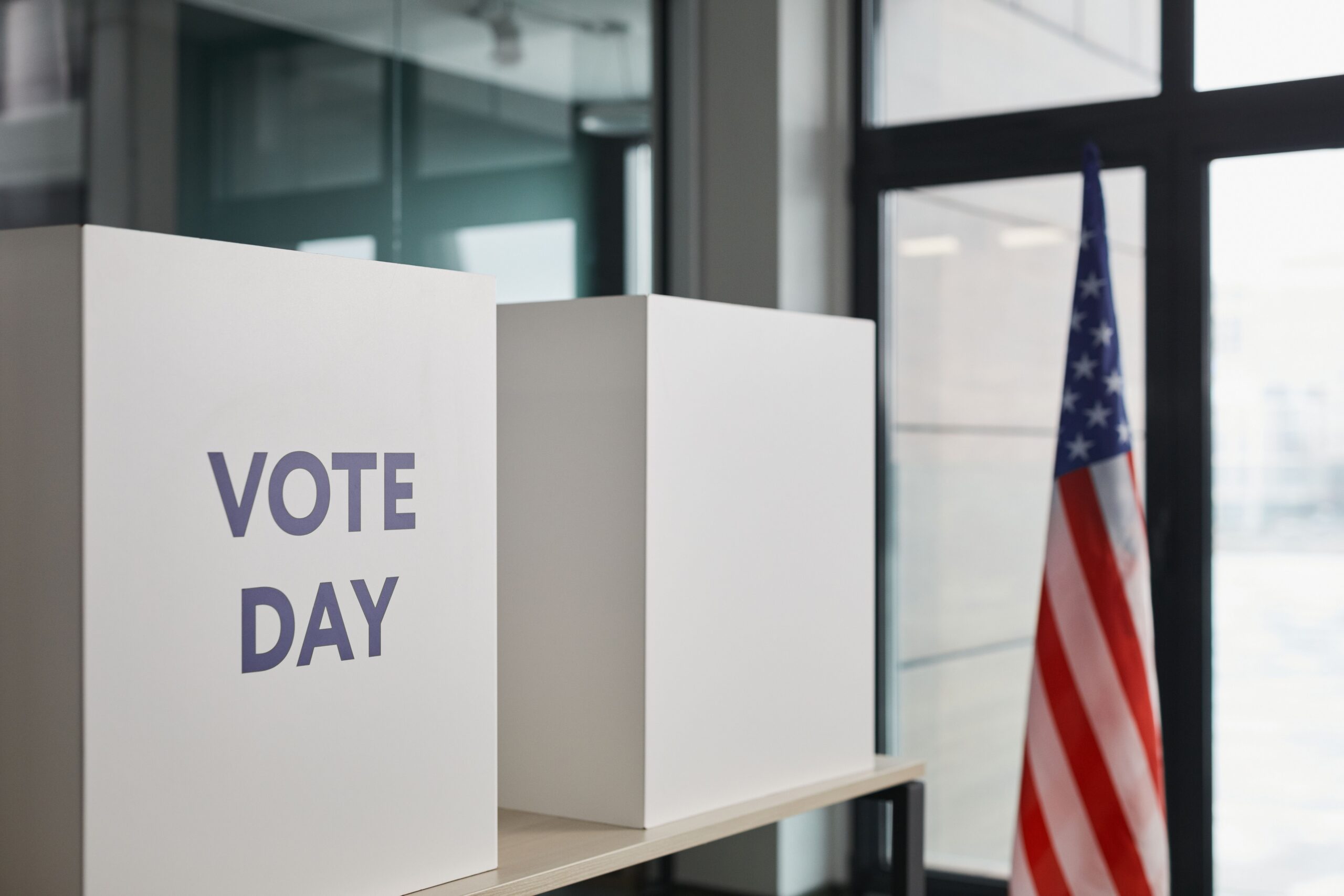 Voting booths with an American flag