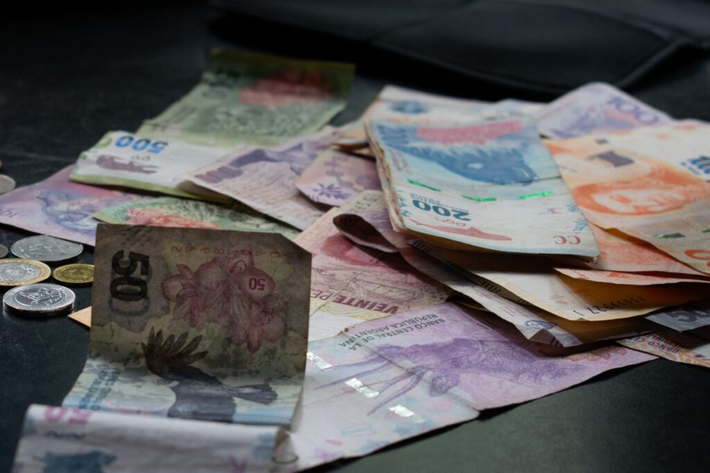 A mix of international banknotes and coins on a table