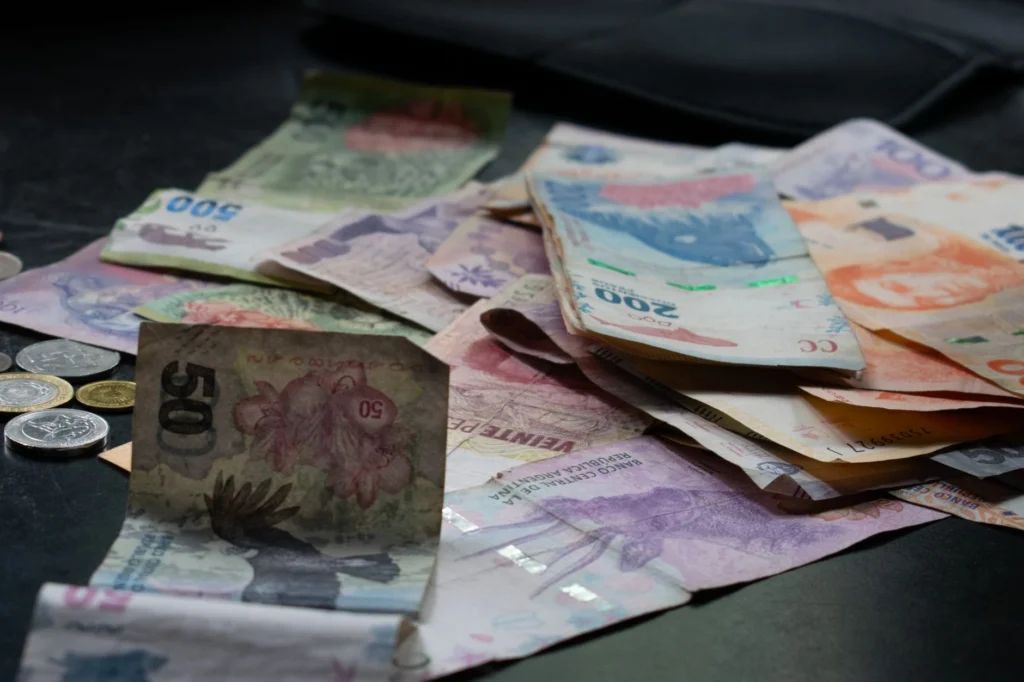 A mix of international banknotes and coins on a table